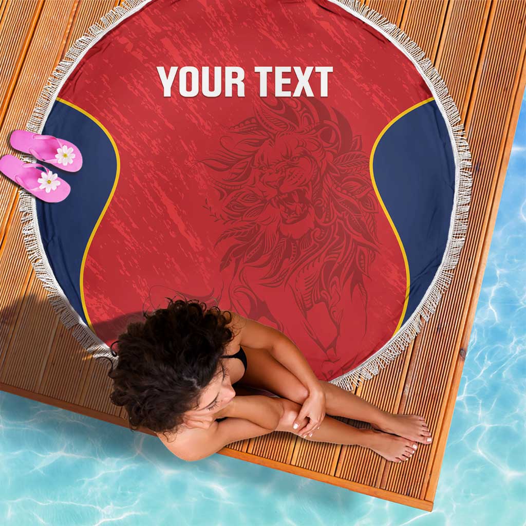 Red round beach blanket with white fringe edge, blue/yellow curved sides, 'YOUR TEXT' center