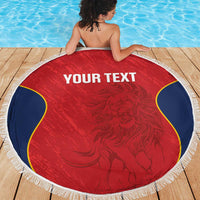 Red circular beach blanket with white fringe trim, blue-and-yellow curved accents, 'YOUR TEXT'