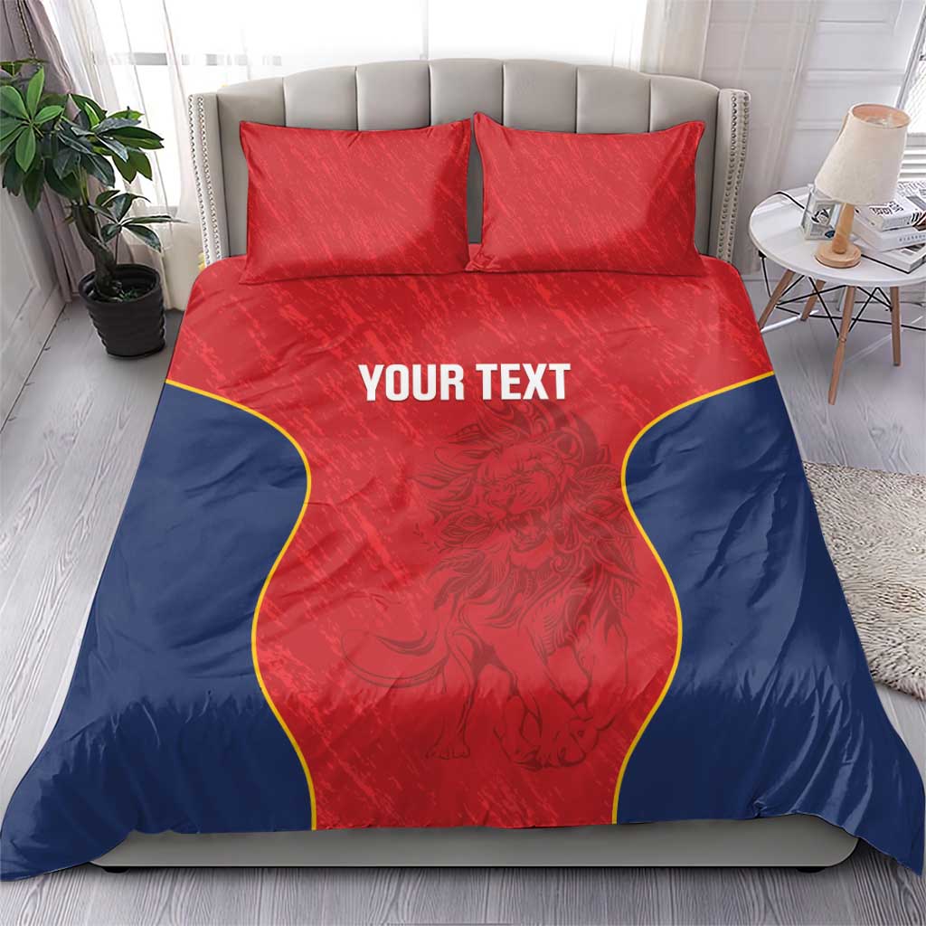Red and navy duvet cover with two pillows; yellow trim around a central panel reading “YOUR TEXT”