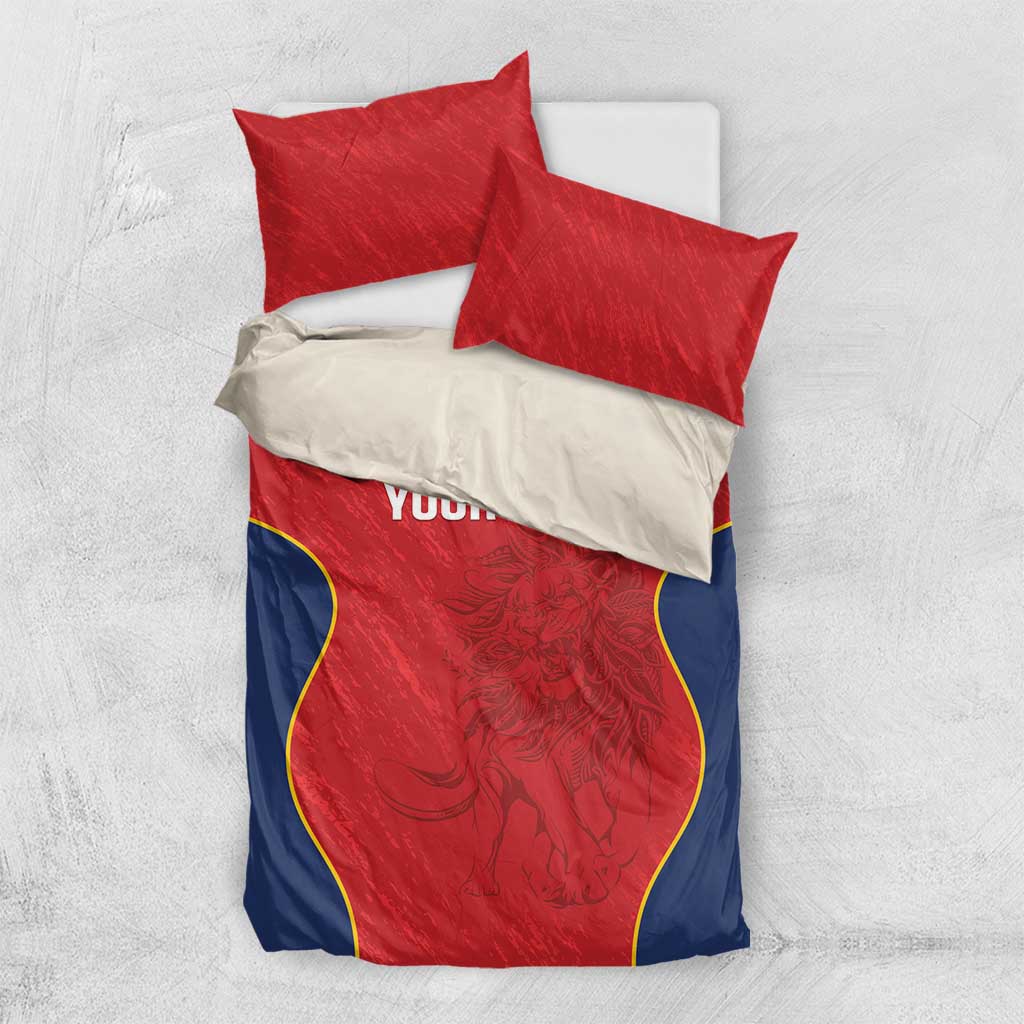 Red and navy bedding set with two red pillows and duvet; yellow-edged graphic panel “YOUR TEXT”