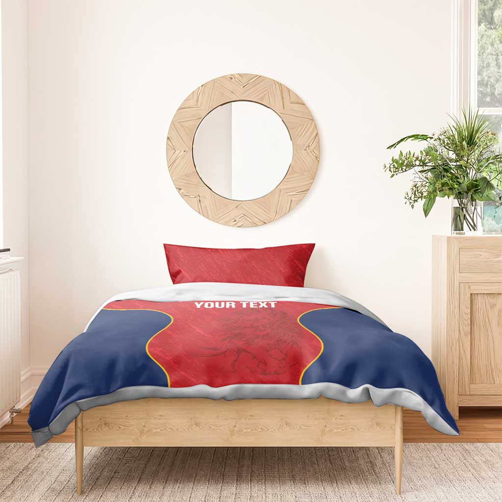 Red and navy duvet set with one red pillow; yellow-outlined design and “YOUR TEXT” on center