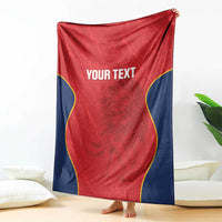 Red Spain rugby blanket draped indoors, navy border with yellow trim and “YOUR TEXT”.