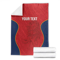 Red Spain rugby blanket with navy sides and yellow outline, shown with folded white towels.