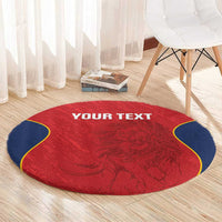 Round red circular rug with navy edging, ornate relief pattern, "YOUR TEXT" centered