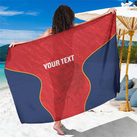 Red and navy rugby sarong with yellow trim and centered text panel, draped