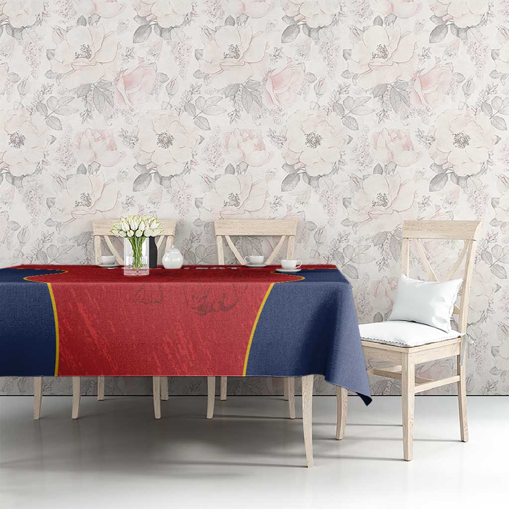 Custom tablecloth draped on long table: red panel, navy sides, yellow border