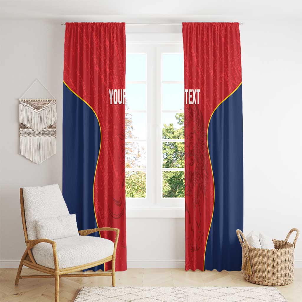 Two red window curtain panels with navy sections and yellow curved border, full view on window