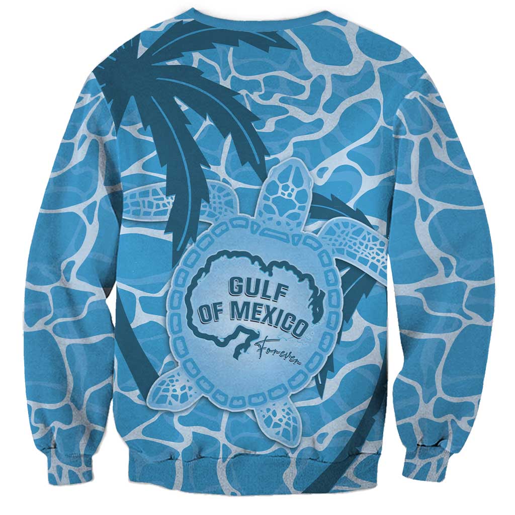 Blue crewneck sweatshirt with large front turtle emblem and palm tree graphics