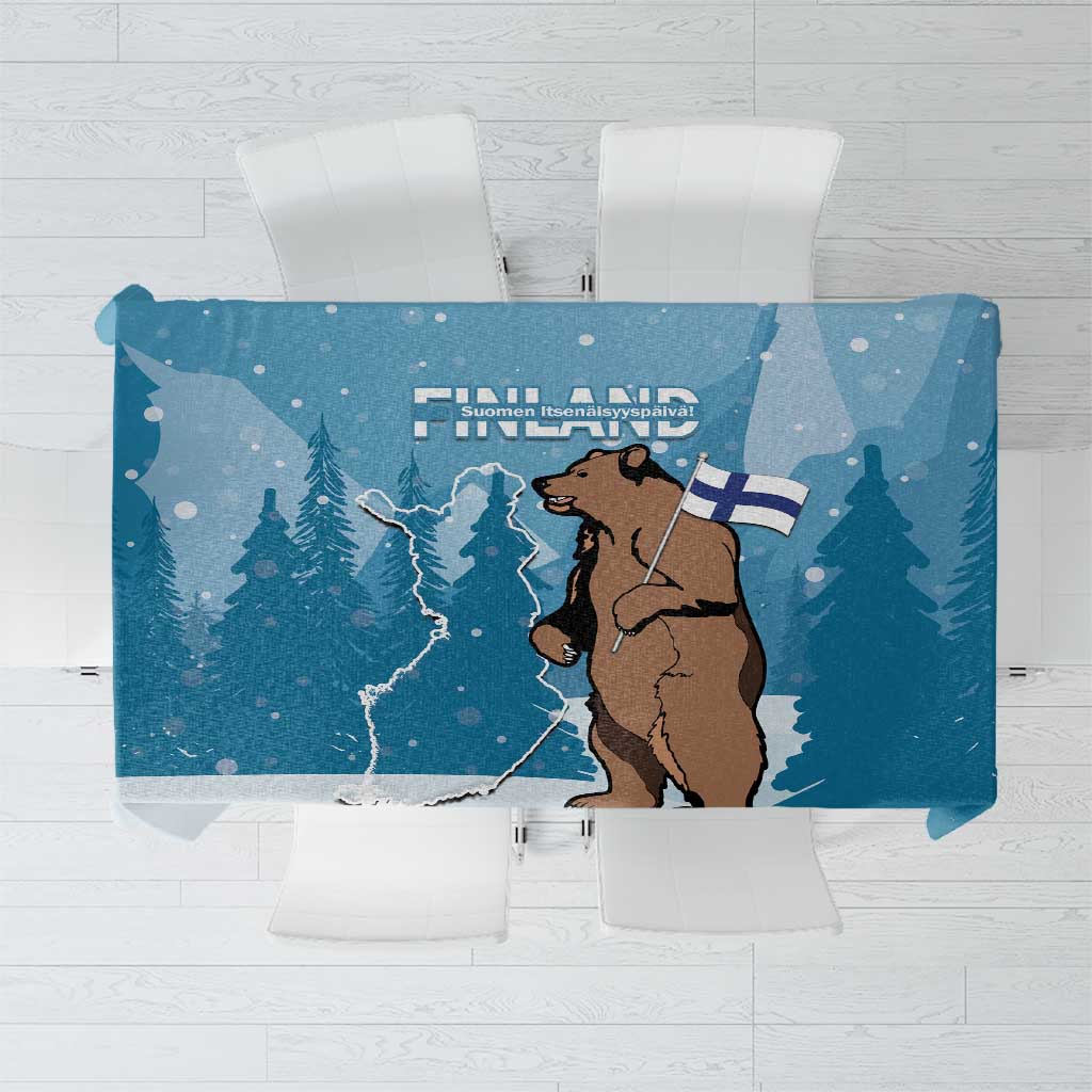 Blue printed tablecloth with Finland outline, bear figure, flag, and pine trees
