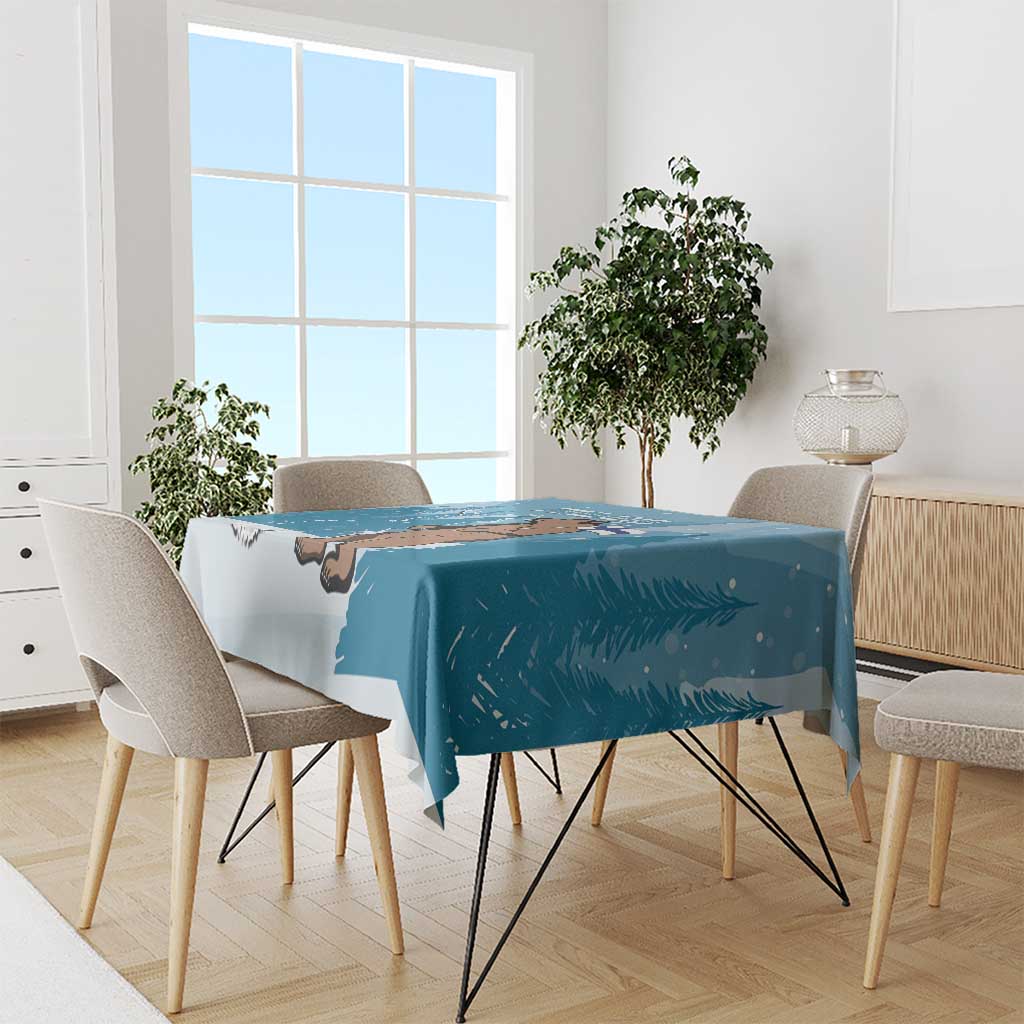 Blue Independence Day tablecloth draped on table, featuring Finland and bear artwork