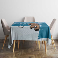Blue tablecloth on dining table with central bear face, Finland outline, and trees