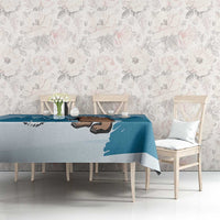 Blue printed tablecloth on table with bear graphic, Finland outline, and pine trees