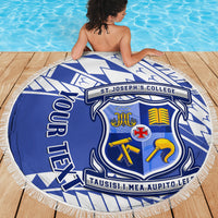 Personalized round blue and white beach blanket featuring crest badge and fringed edge