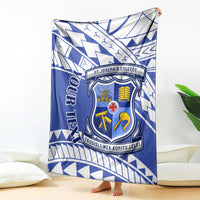 Blue and white St Joseph's College crest blanket with geometric Samoan pattern, draped on bed