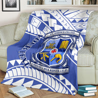 Blue and white St Joseph's College crest blanket with geometric pattern, covering a couch