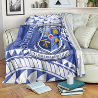 Blue and white St Joseph's College crest blanket with geometric border on a bed