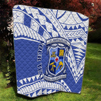 Blue and white quilt featuring St Joseph’s College shield crest and geometric pattern