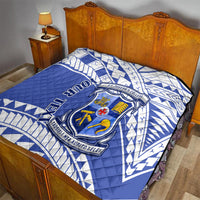 Blue quilt with white geometric print and St Joseph’s College crest on bed