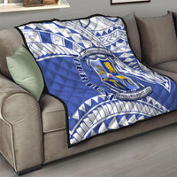 Blue and white quilt with St Joseph’s College crest on a sofa cushion
