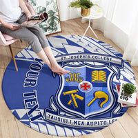 Round blue patterned carpet rug on floor, central crest emblem and blue border