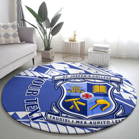 Round blue patterned rug with centered college crest and bold banner text