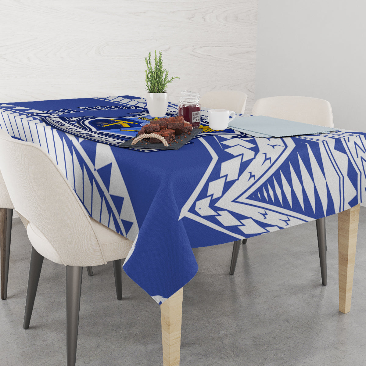 Blue and white geometric patterned tablecloth on dining table with chairs