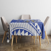 Blue geometric tablecloth with crest panel on small square table
