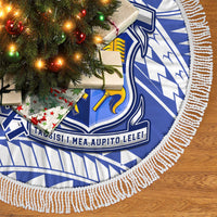 Blue and white tree skirt with fringed edge and crest emblem, close-up