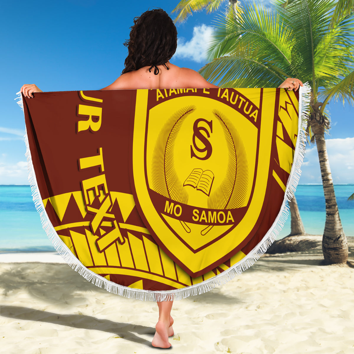 Round fringe beach blanket held on sand; Samoa shield crest in gold and maroon pattern