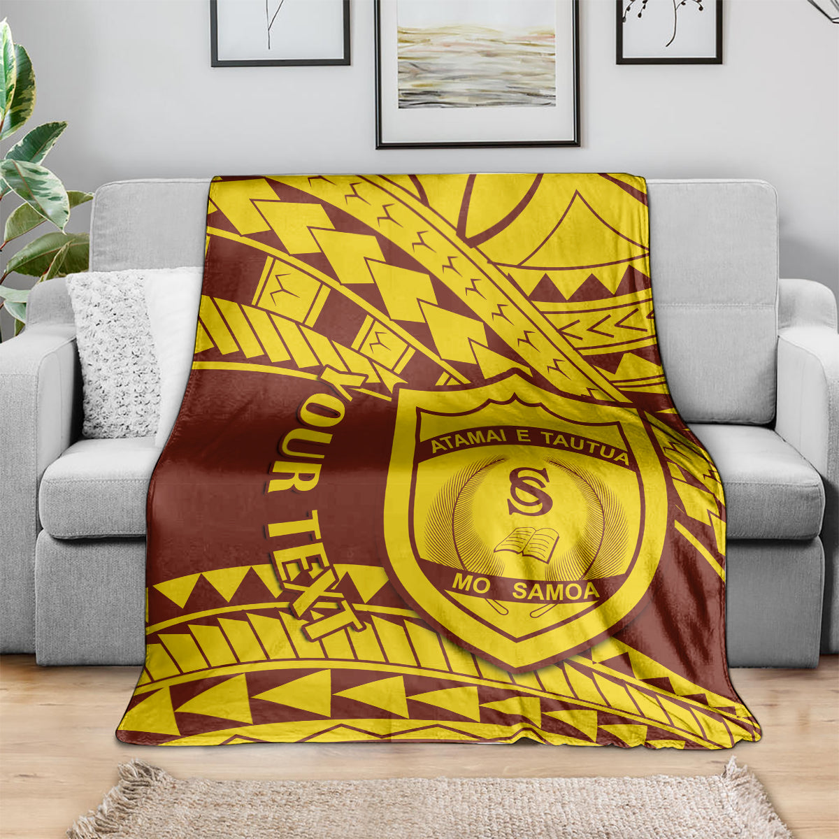 Maroon and gold shield-crest college blanket draped over a sofa