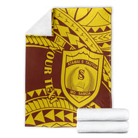Maroon and gold shield-crest college blanket neatly folded with visible edge