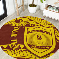 Round rug with maroon and yellow geometric Samoan pattern, shield crest and MO SAMOA text