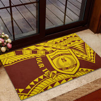 Brown and gold Samoan patterned rubber doormat with crest, laid outside on steps