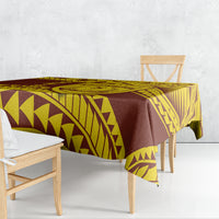 Maroon and gold geometric patterned tablecloth draped over dining table