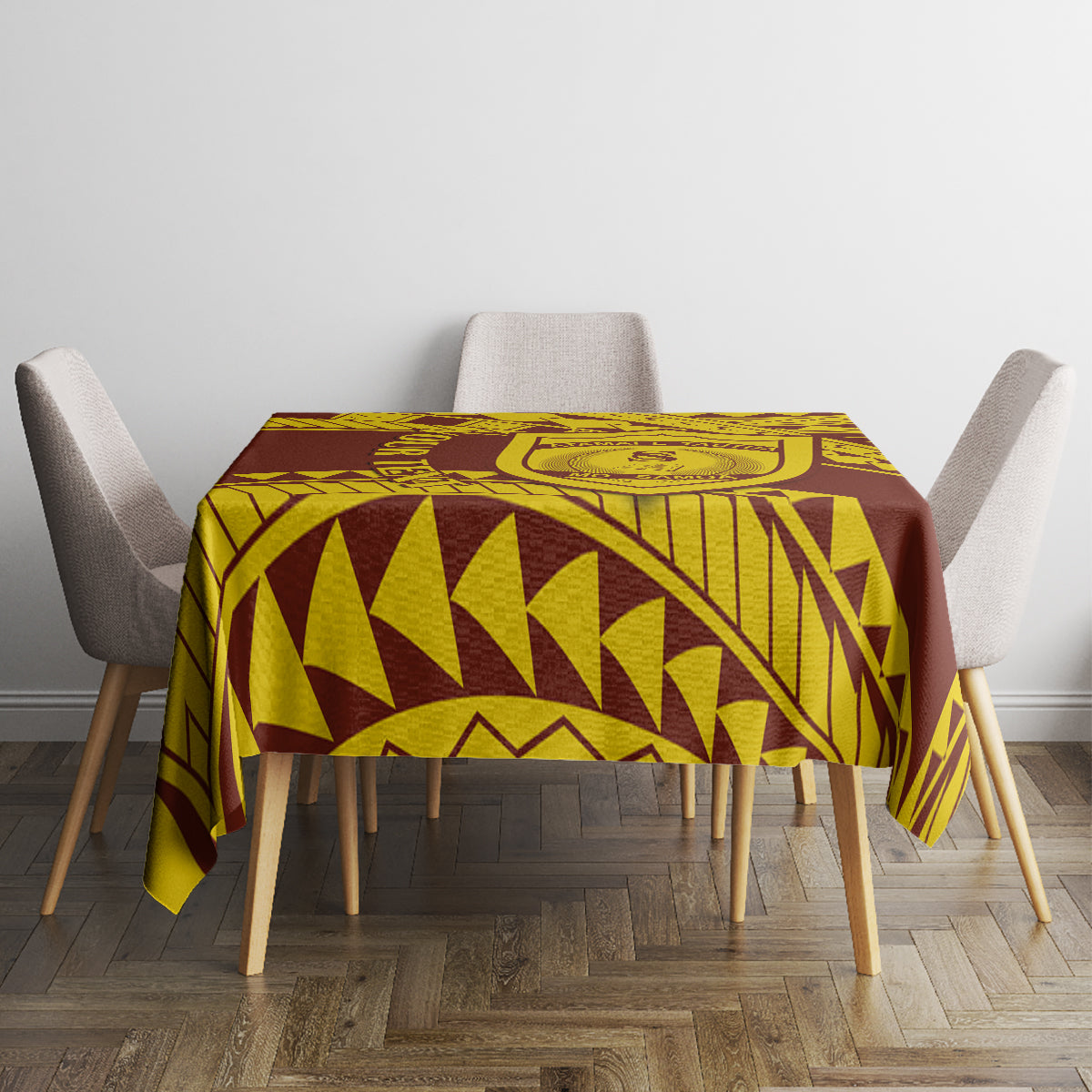 Gold and dark brown geometric tablecloth with crest motif on dining table