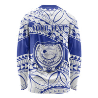 Blue and white long-sleeve shirt with tribal pattern and circular crest logo, back text