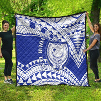 Blue and white Samoan pattern college quilt spread out, showing large crest emblem