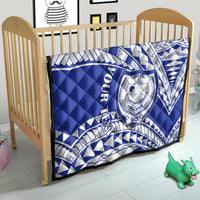 Blue and white Samoan crest quilt on a small bed with diagonal patterned design