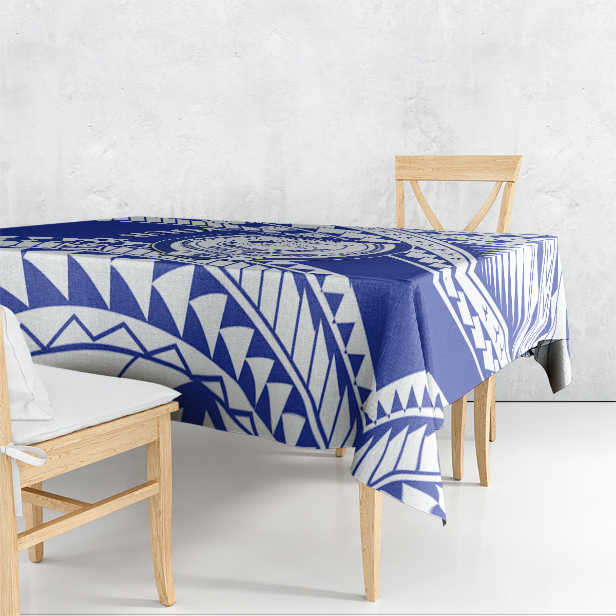 Blue and white Samoan geometric patterned tablecloth draped over a table