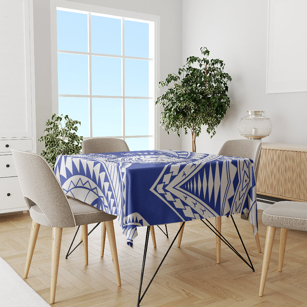 Blue and white Samoan patterned tablecloth on dining table with chairs