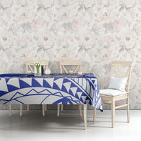 Blue and white geometric patterned tablecloth on dining table with chairs