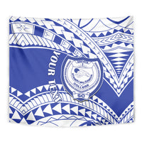 Close-up blue and white tapestry with circular SAFATA college crest and Samoan-style patterns