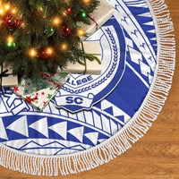 Blue and white round fringed tree skirt with geometric pattern and central emblem