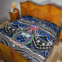 Blue, black, and white Samoa 685 quilt laid on a bed with central coat-of-arms