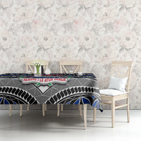 Blue tablecloth laid on table with Samoa coat of arms and patterned border design