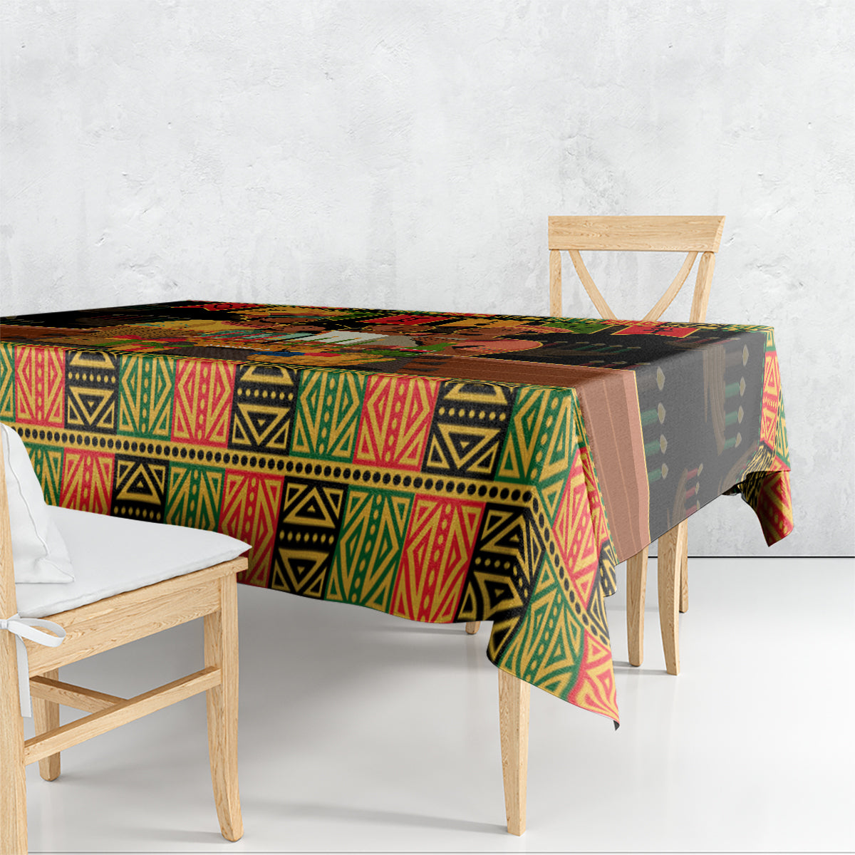 Black tablecloth with red, green, and yellow African motif draped over dining table
