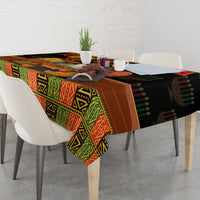 Black tablecloth with colorful African pattern covering tabletop and hanging corners