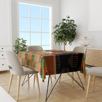 Black African-pattern tablecloth with colorful trim on dining table and chairs