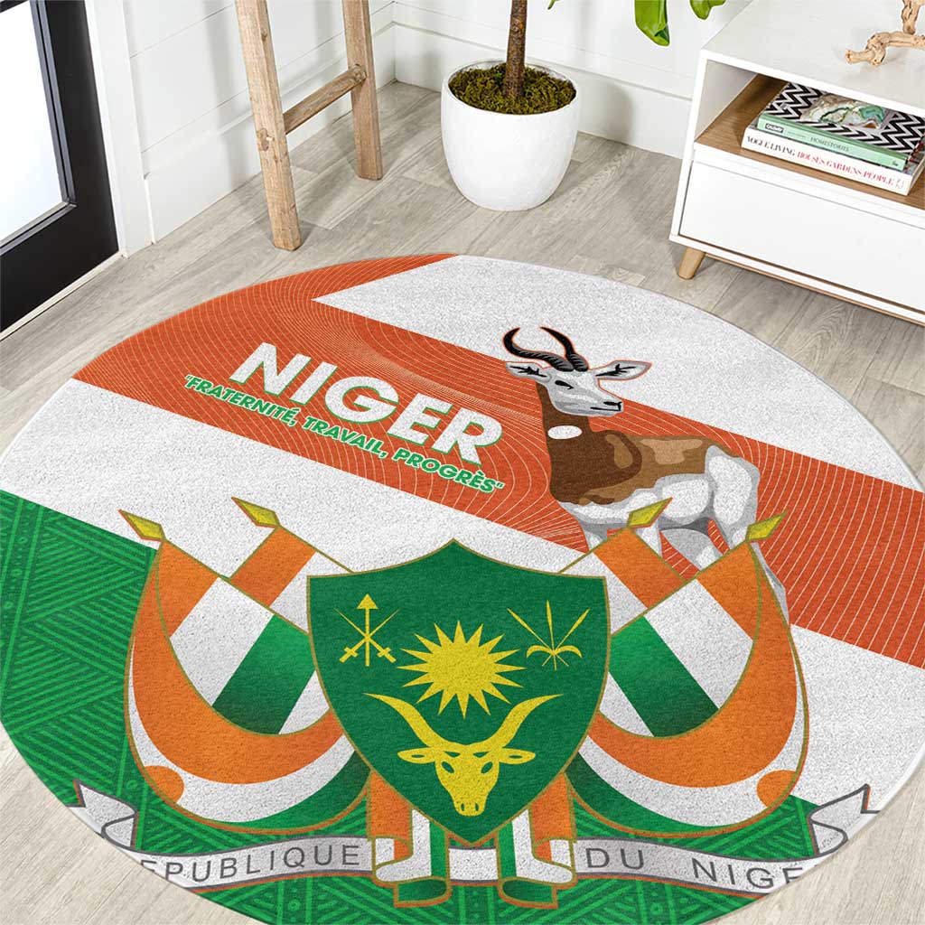 Round carpet in orange, green, and white with Niger coat of arms and gazelle graphic
