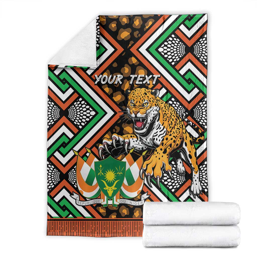 Folded personalized leopard and Niger-themed throw blanket with "YOUR TEXT" on black geometric pattern
